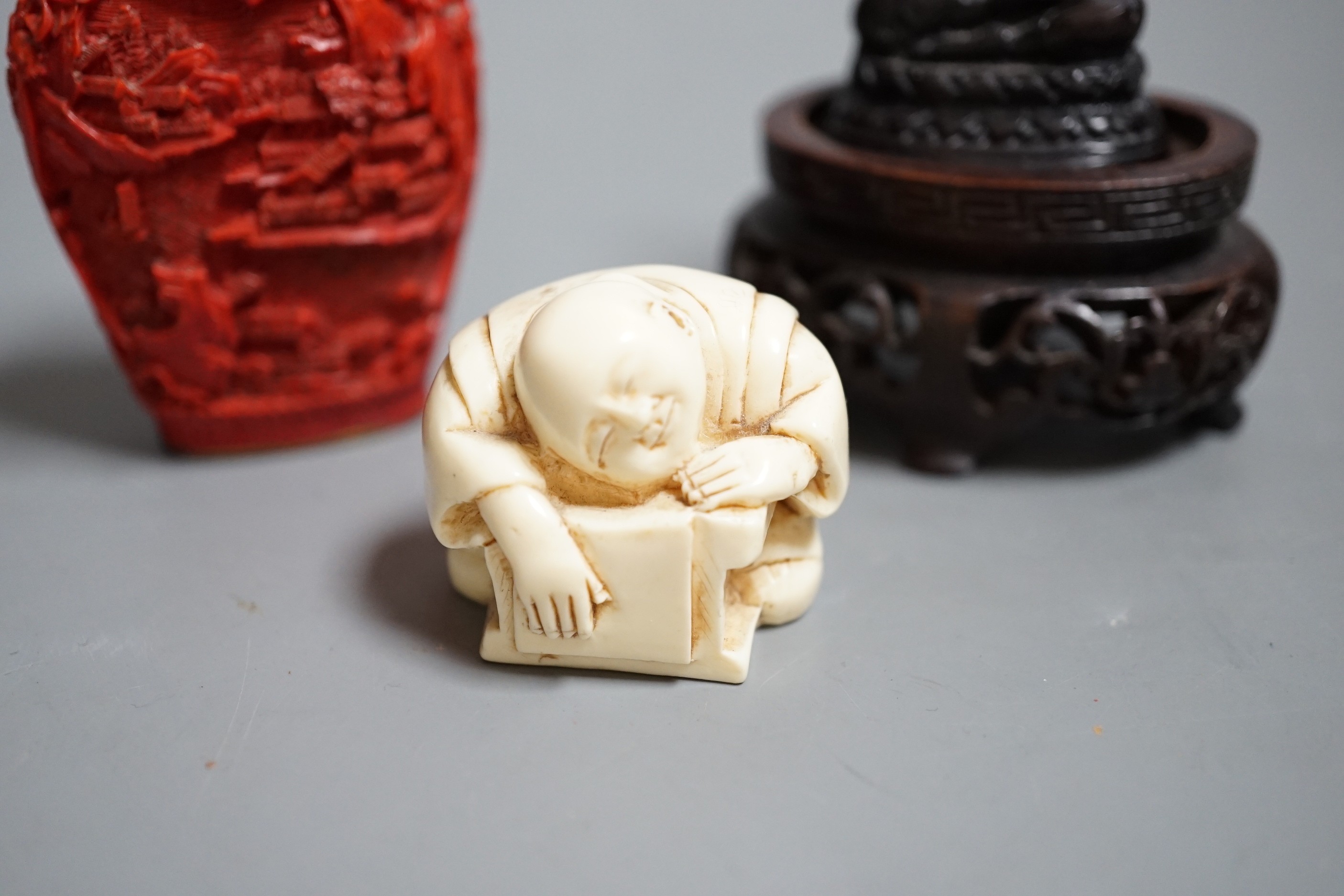 A Chinese resin snuff bottle, a resin Buddha on stand and a resin netsuke